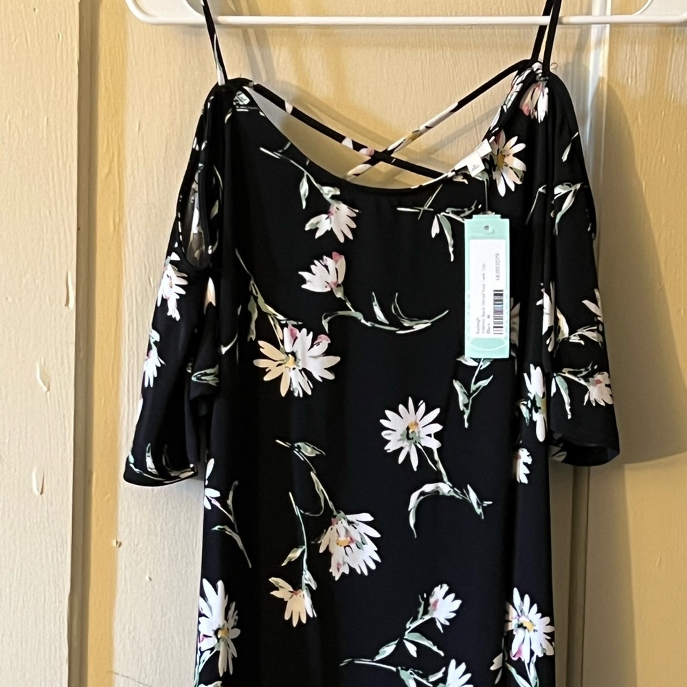 Black floral shirt with spaghetti straps and sleeves that hang off the shoulder